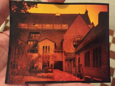 The church I live in, seen from the garden. It’s been converted to an apartment building. You see the balconies that have been scooped out of the original roof. There are only shades of orange and red in this image, because I over-compensated the green cast of the first attempts.