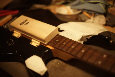 Overview over the bass. There’s white protective tape over the black paint.