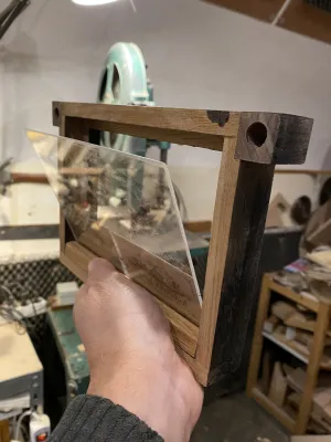 The focus screen, still unsanded. The frame only partly painted black. It is in my left hand, and the plastic ground 