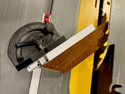 Cutting one of the four edges of the door at 45 degrees without losing a finger. The table saw has a tool for that, and I taped the wood to it using double side tape, so it did not slide