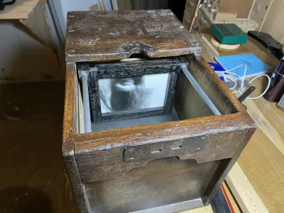 A view into the camera. In the focus screen is a test negative I made. It shows my forehead, upside down.