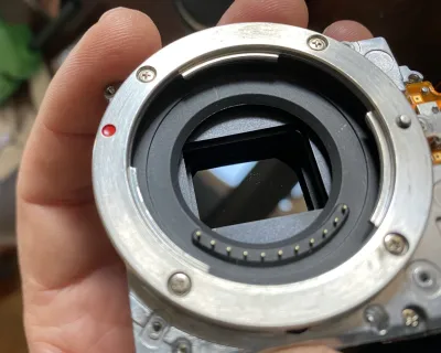 My hand holding the part that has the lensmount and the sensor in it. The black shiny bit is the converted sensor.